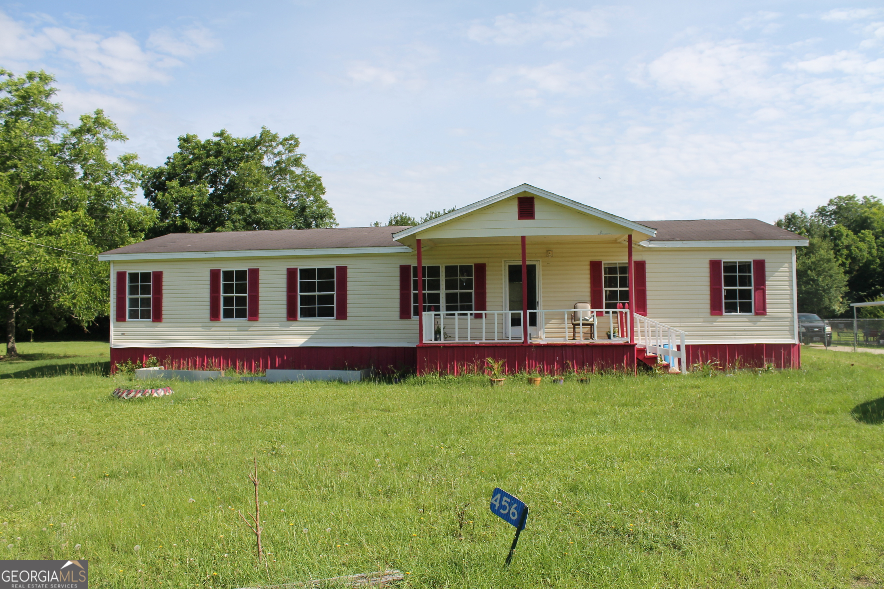 a front view of house with yard and outdoor seating