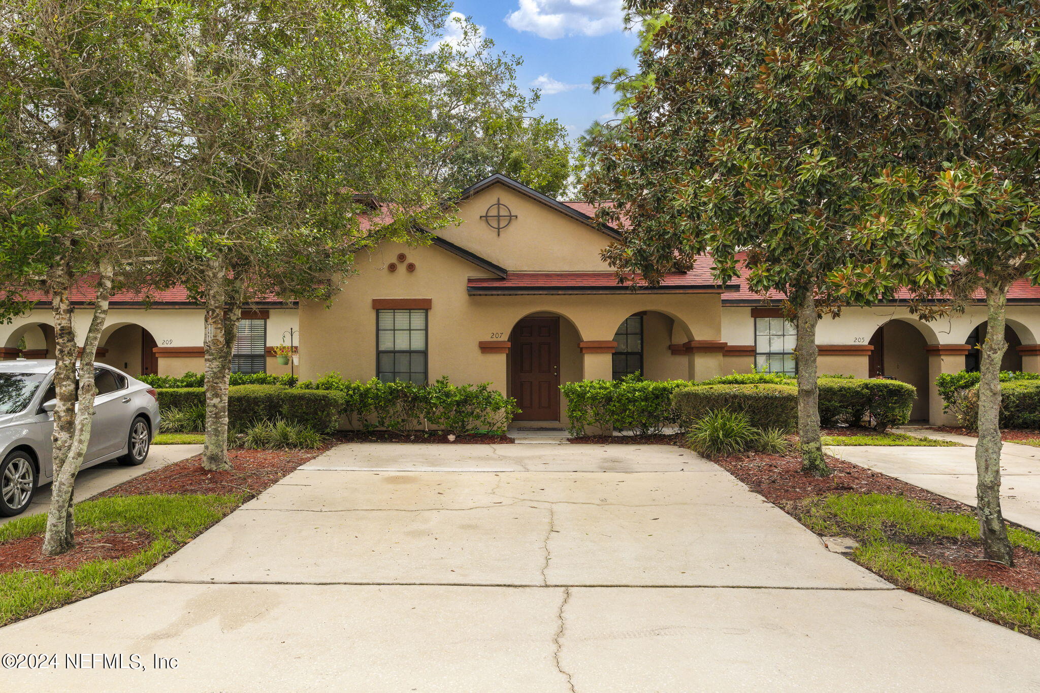 a front view of a house with garden