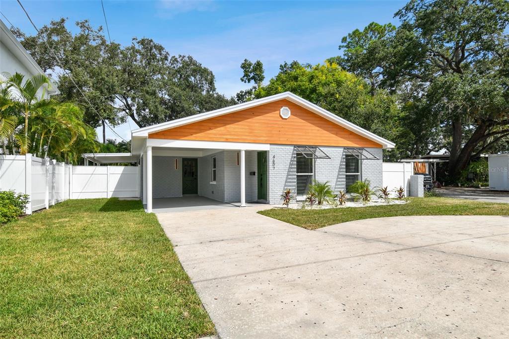 a front view of a house with a yard and porch