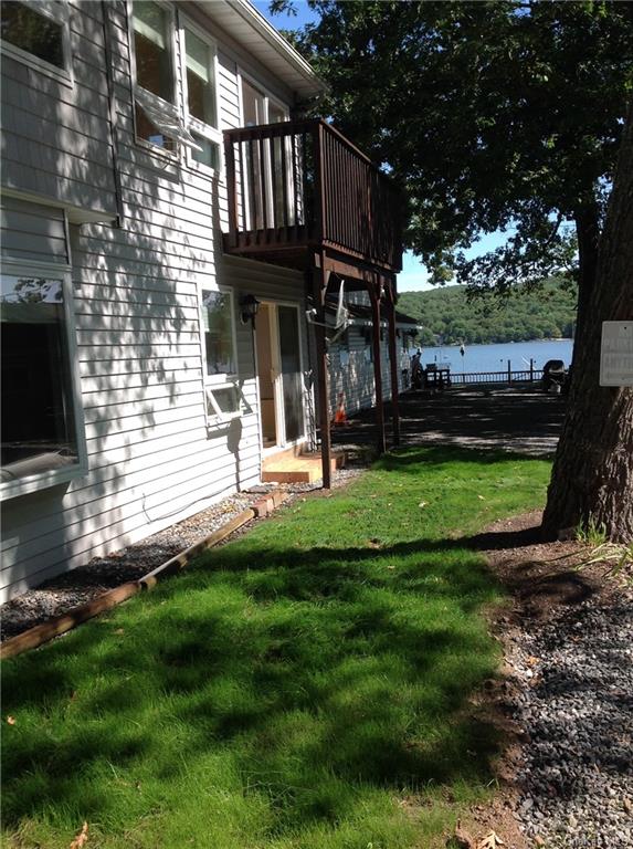 a view of a house with a yard and sitting area