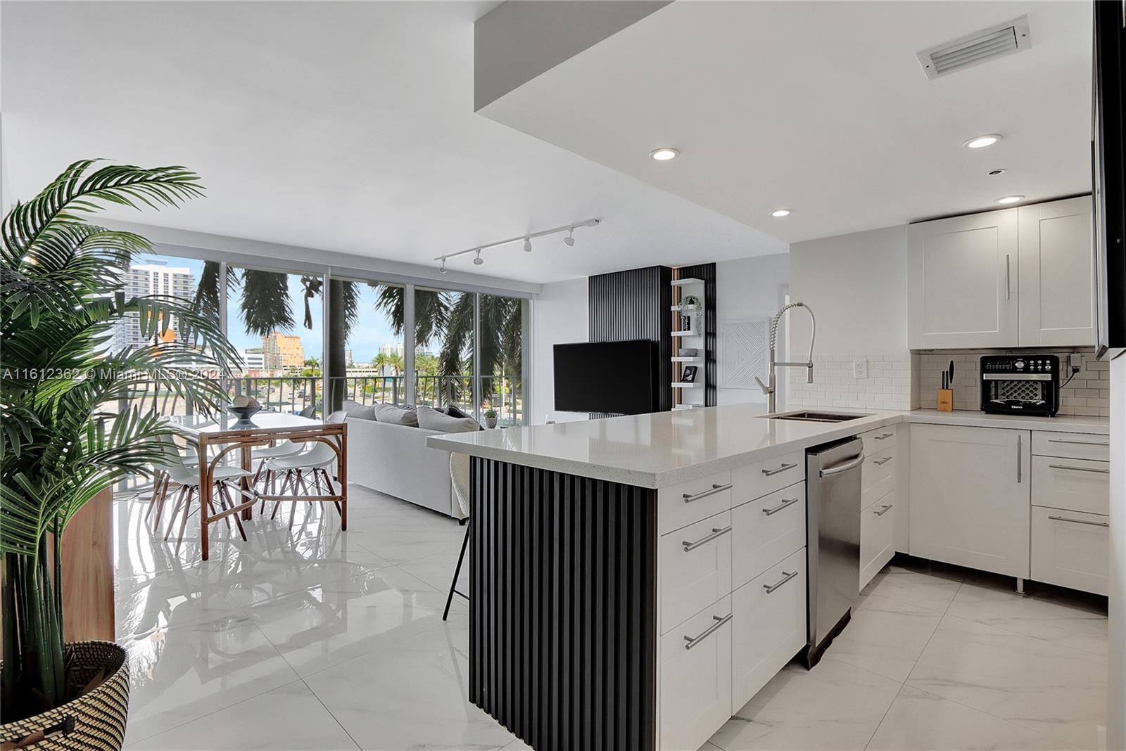 a kitchen with a sink a microwave and cabinets