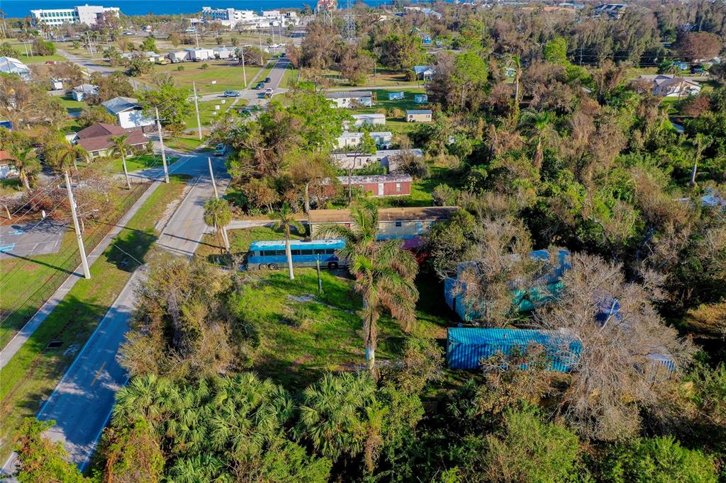 an aerial view of a house with a yard and lake view