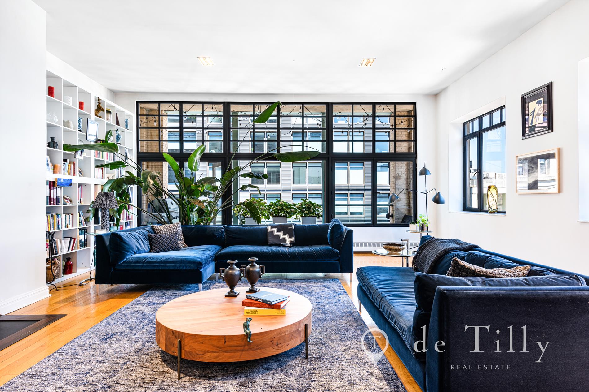 a living room with furniture and a floor to ceiling window