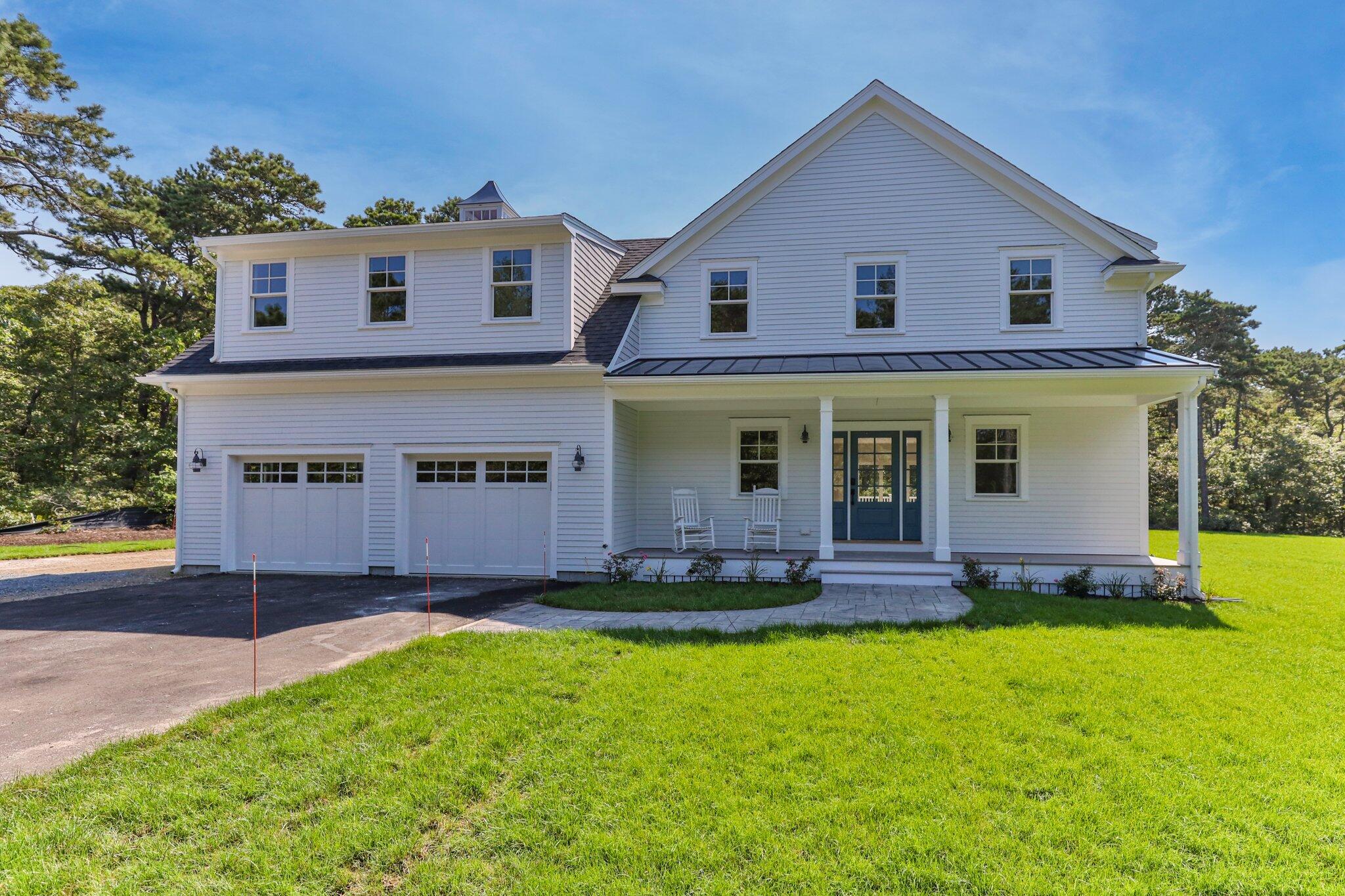 a front view of a house with a yard and porch