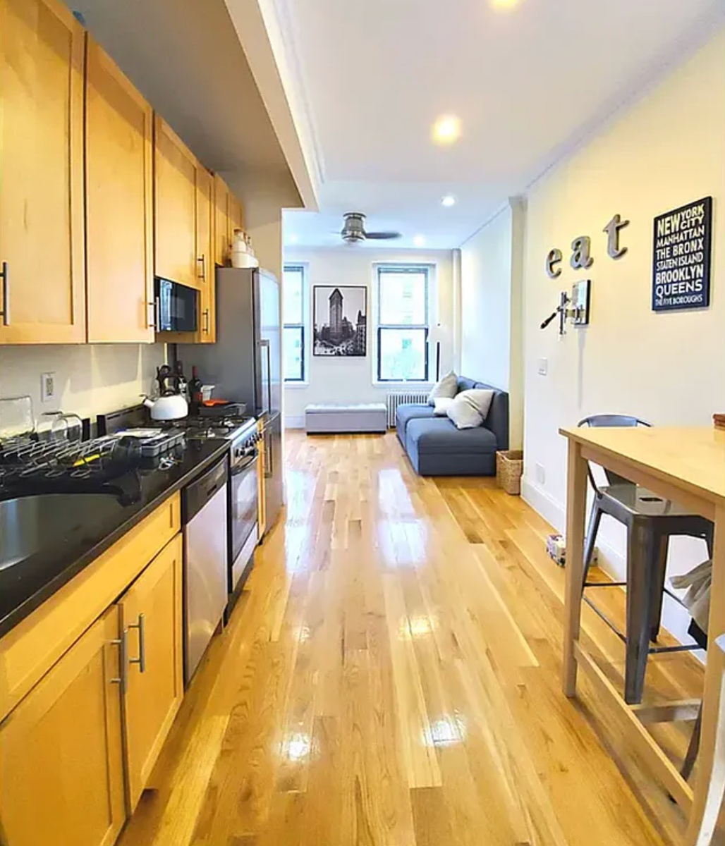 a large kitchen with stainless steel appliances granite countertop a lot of counter space and a window