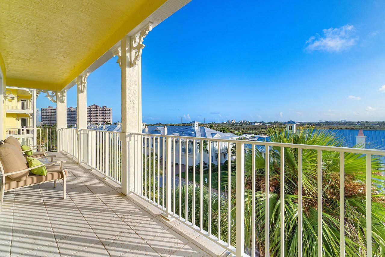 a view of a balcony with floor to ceiling window and wooden floor