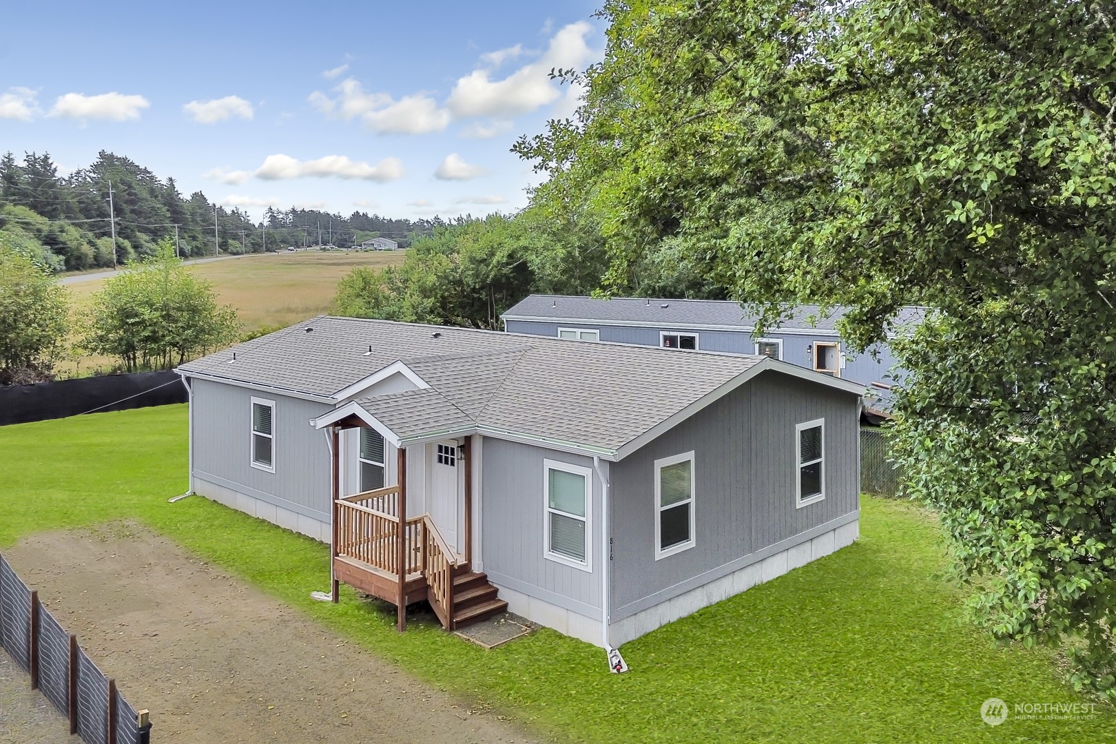 an aerial view of a house with porch yard basket ball court and trampoline