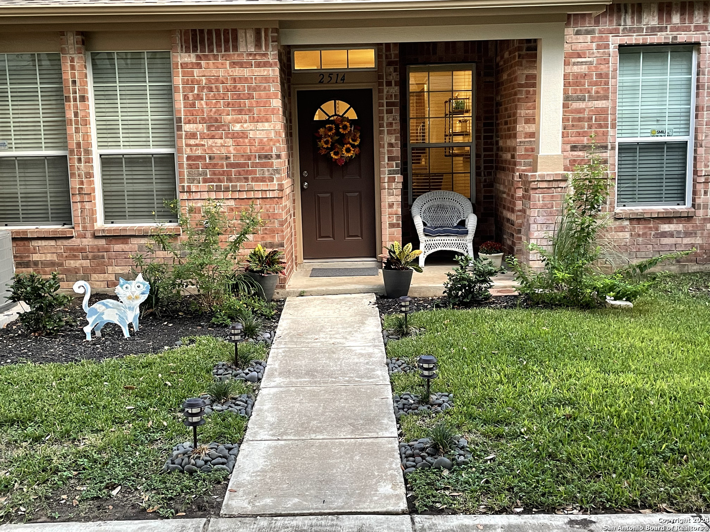 a front view of a house with garden