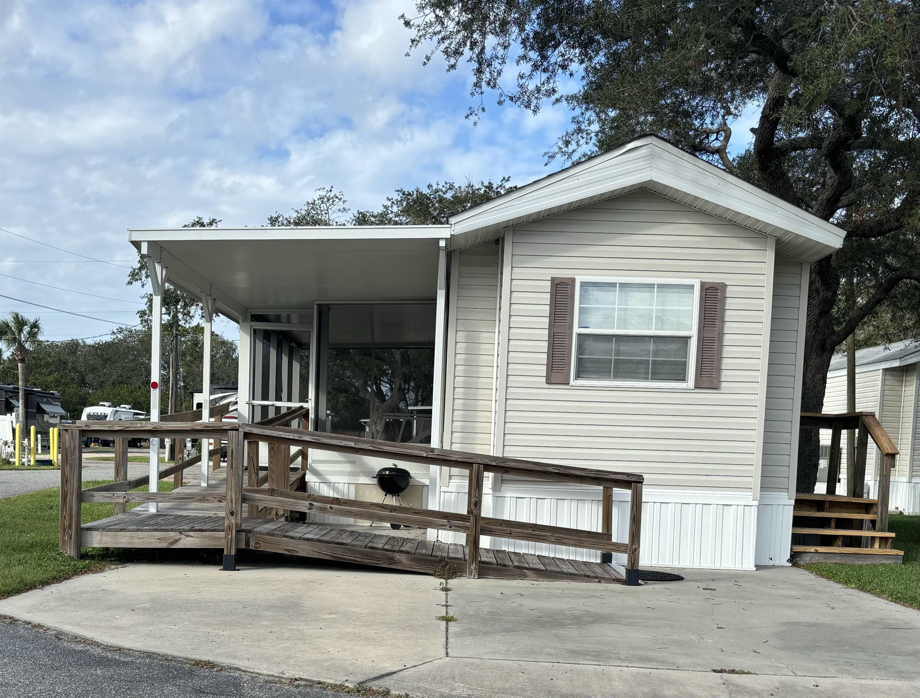 a view of a house with a yard and sitting area