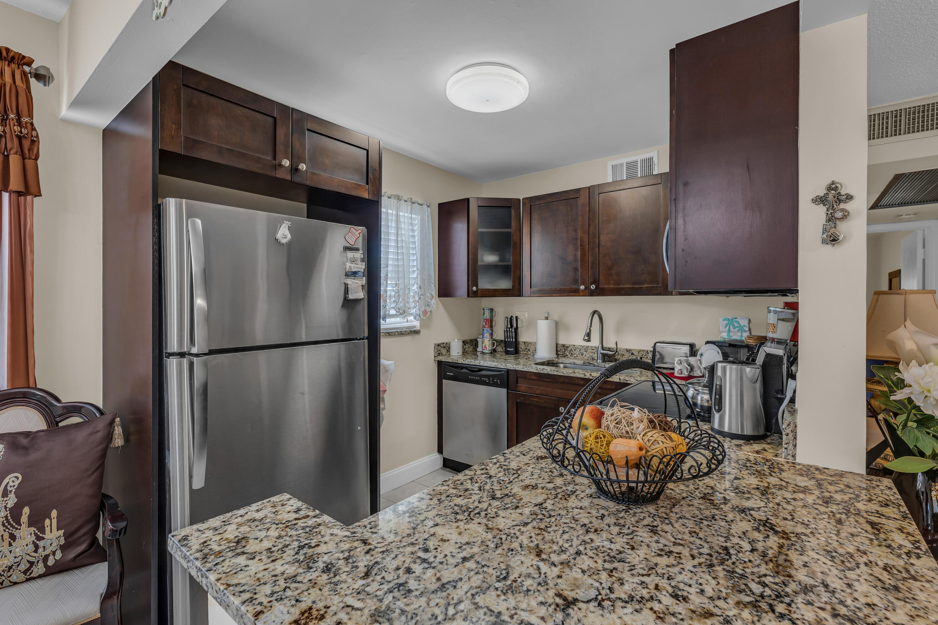 a kitchen with stainless steel appliances granite countertop a refrigerator and a stove