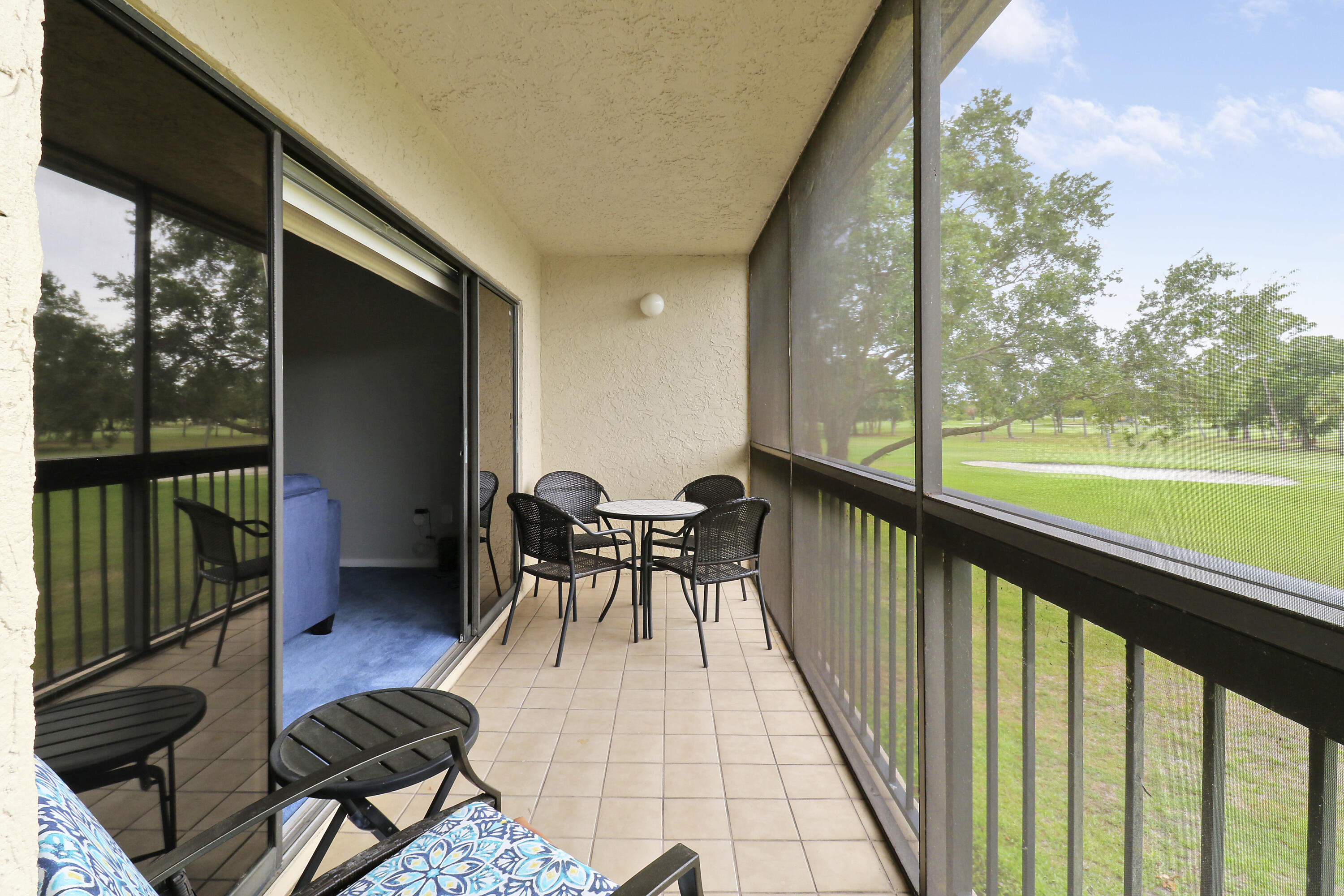 a view of balcony with chairs and wooden floor