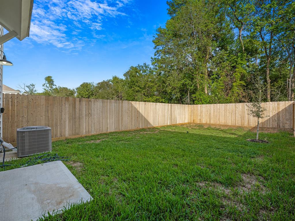 a view of a backyard with a wooden fence