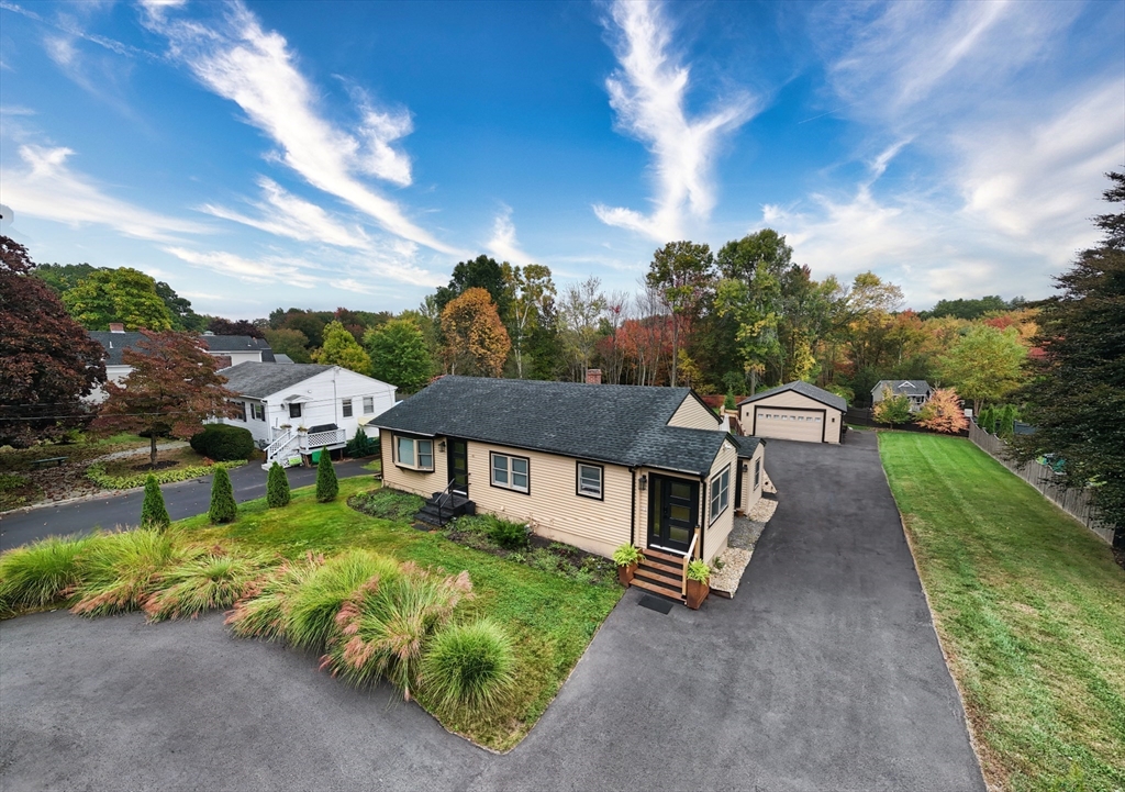 an aerial view of a house with a yard table and chairs