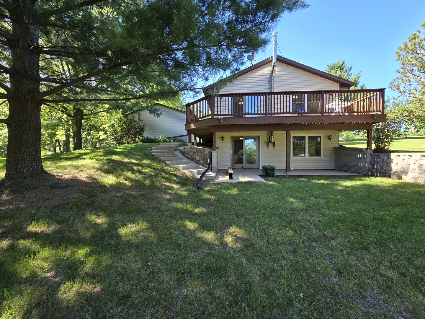 a front view of a house with yard and green space