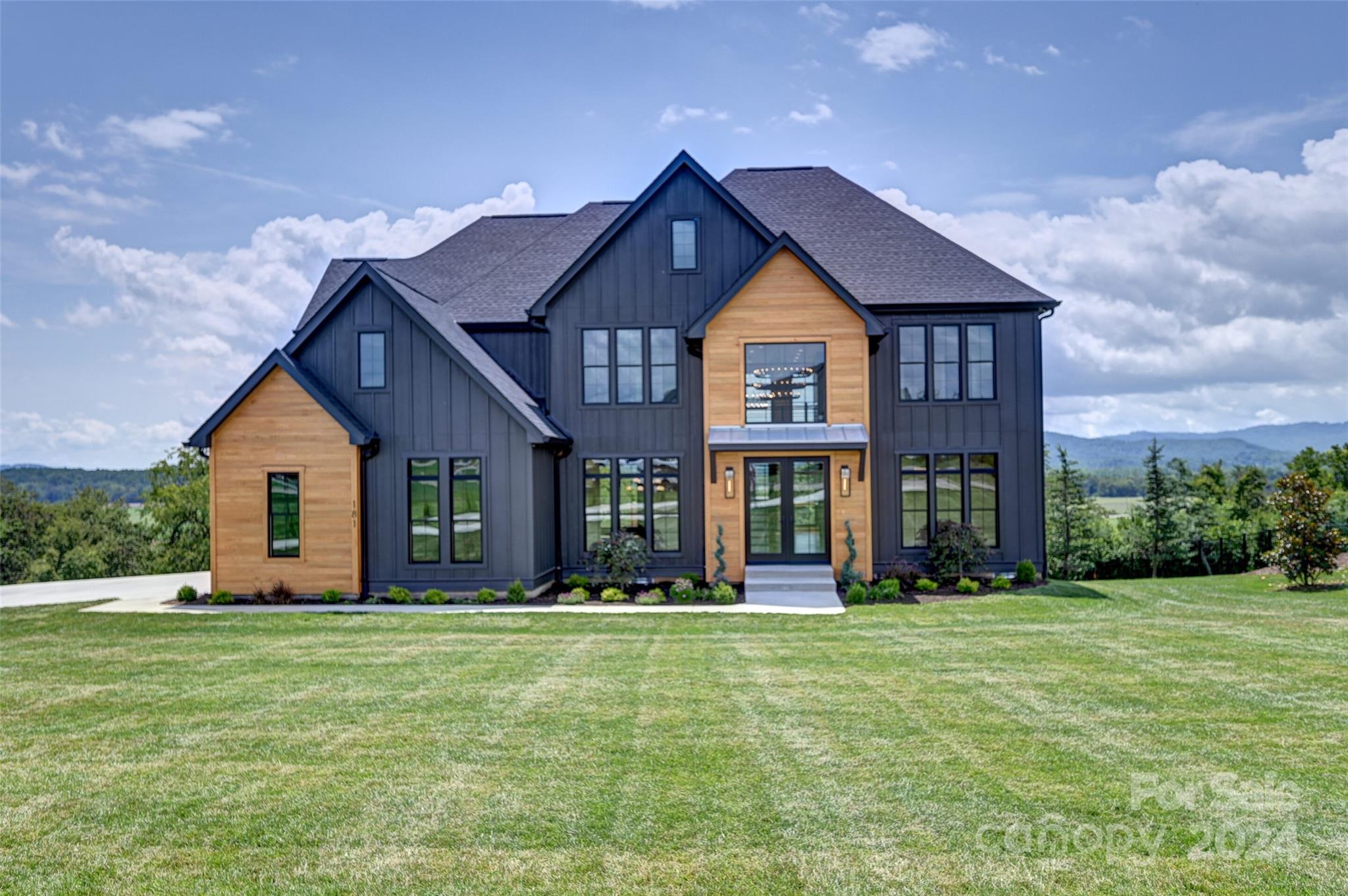 a front view of house with yard and green space