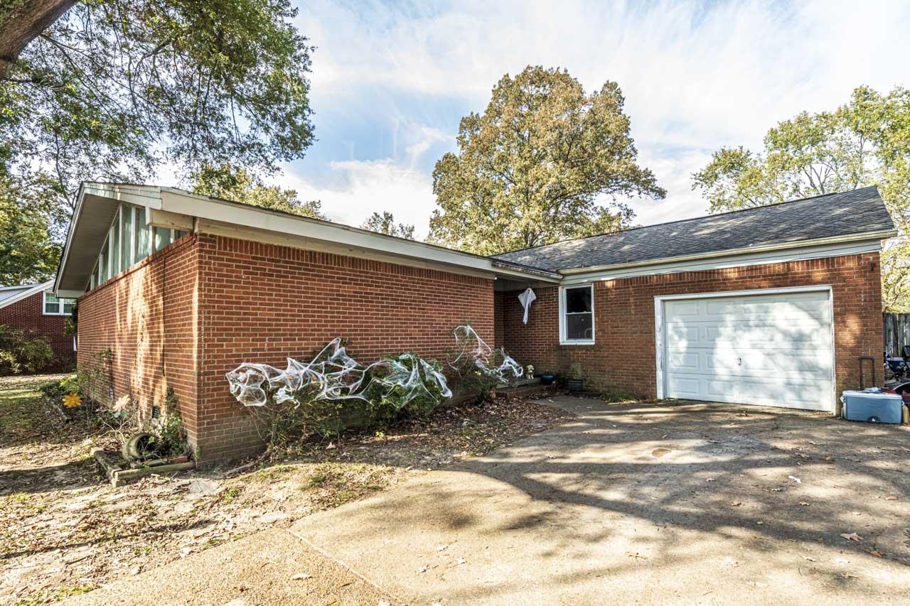 View of front of property featuring central AC and a garage