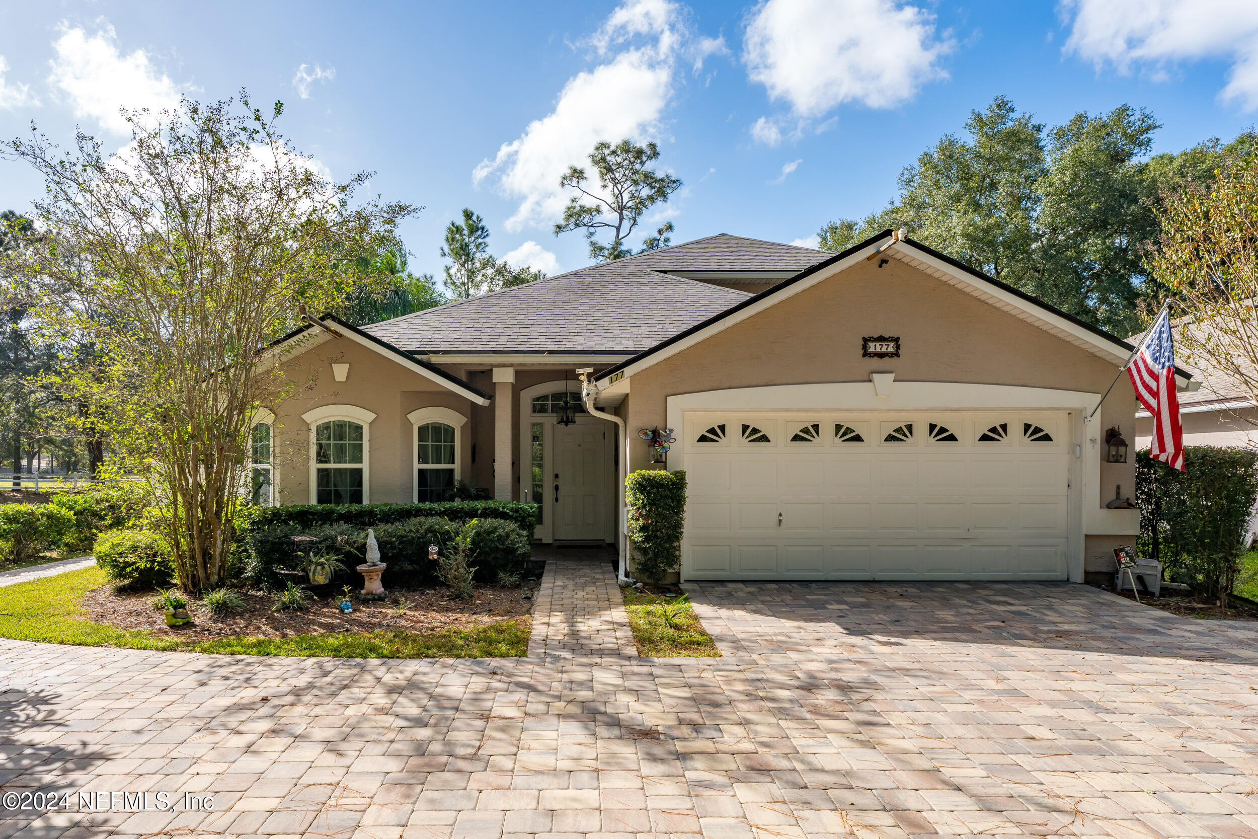 a front view of a house with garden