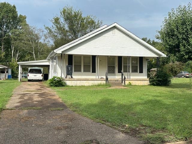 a front view of a house with a yard and porch