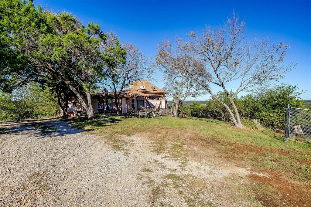 a view of a house with a yard and sitting area