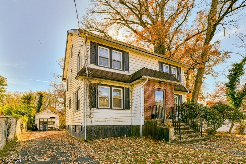 a front view of a house with a trees