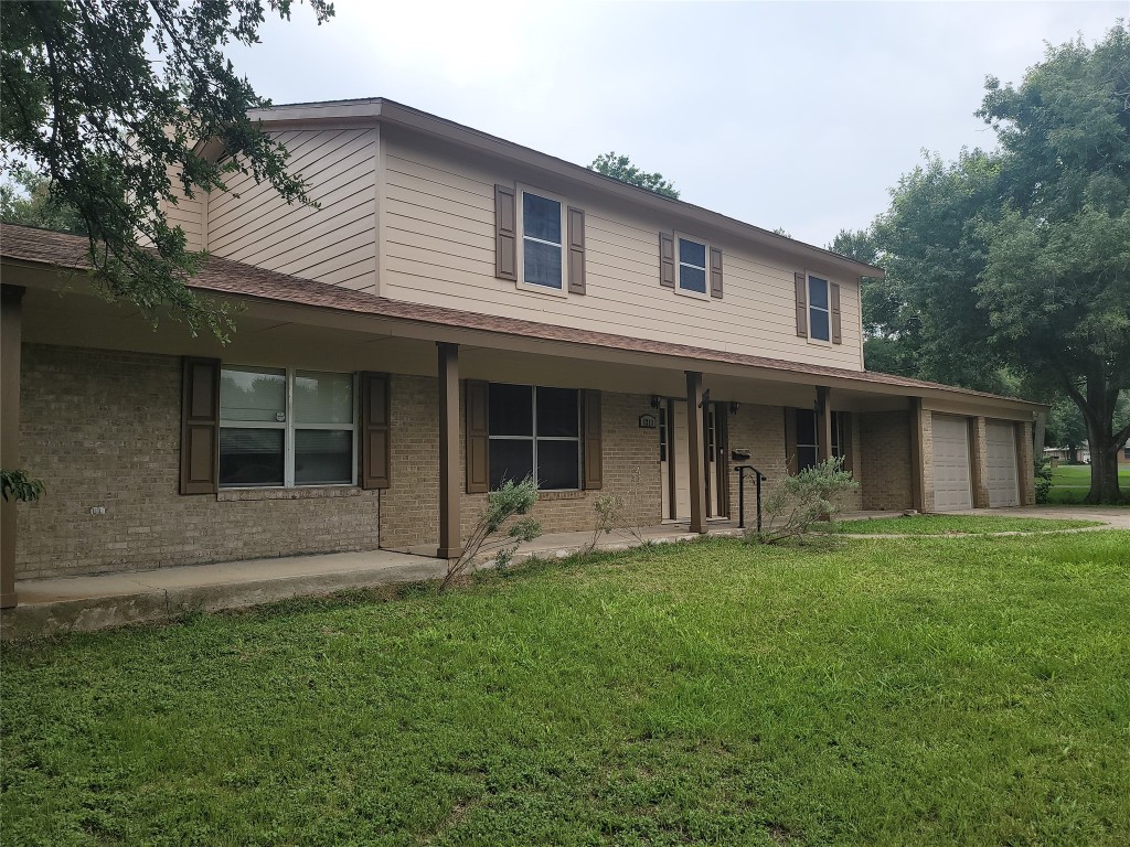 a front view of a house with a garden and porch