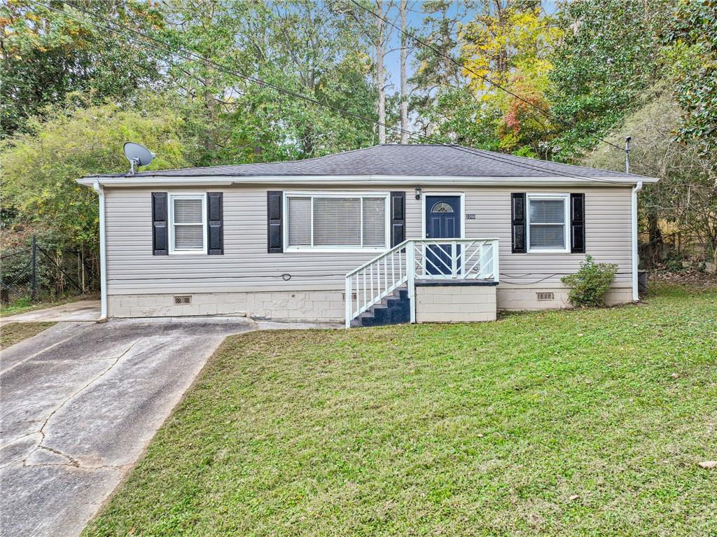 a front view of house with yard and green space