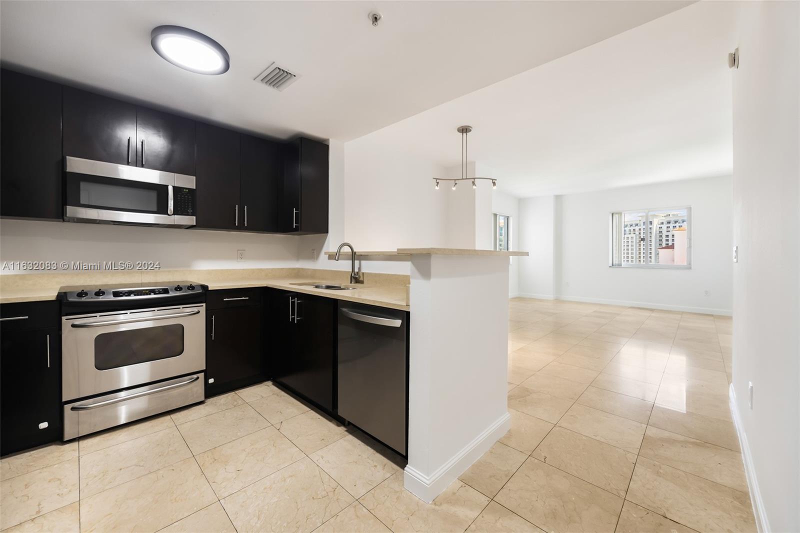 a kitchen with a sink and a stove top oven