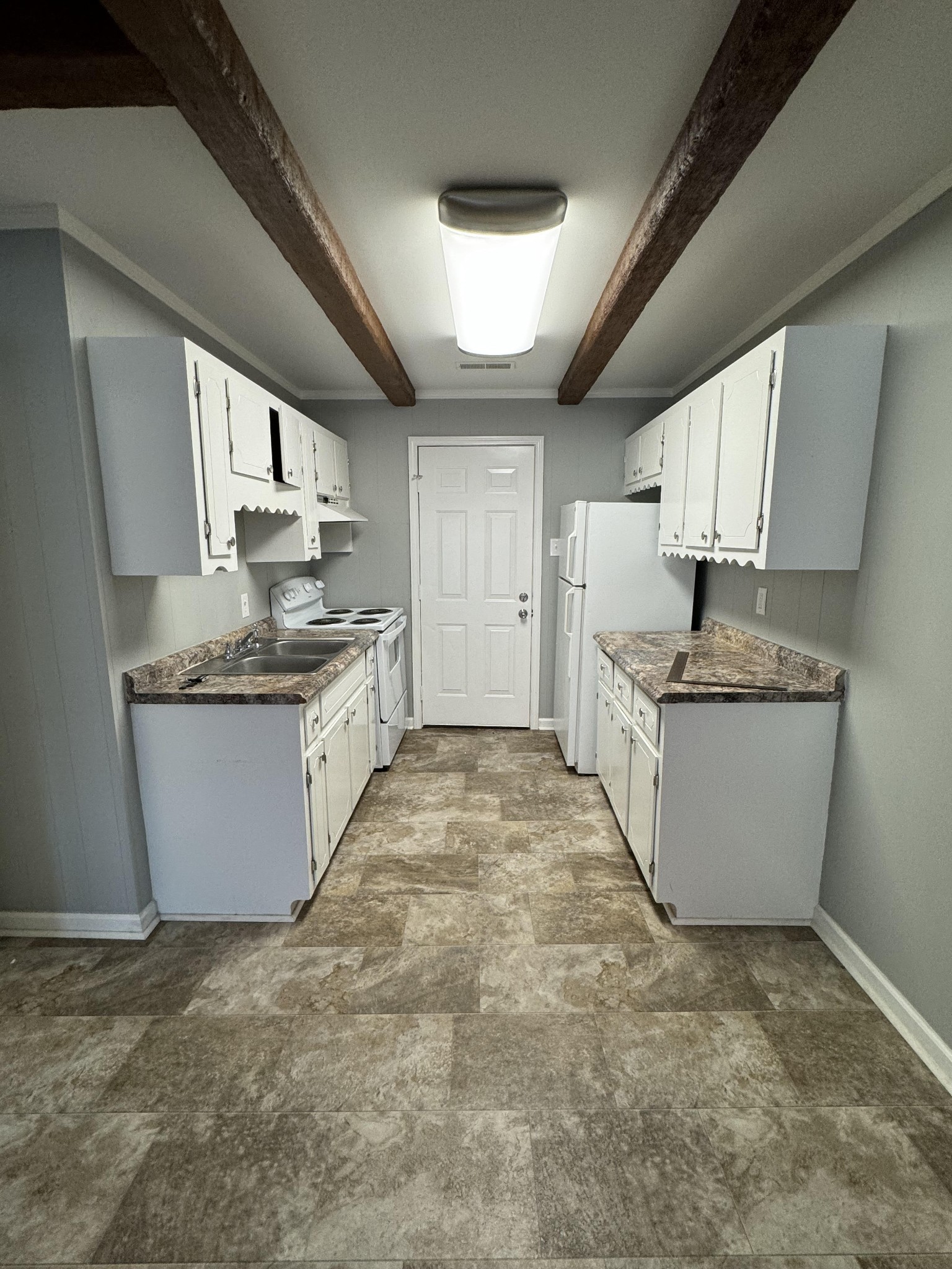 a kitchen with stainless steel appliances granite countertop a stove a sink dishwasher and a refrigerator