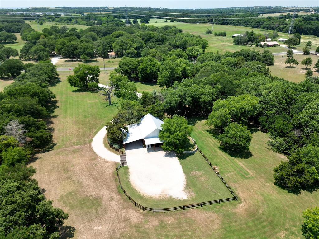 an aerial view of a house with a yard and lake view