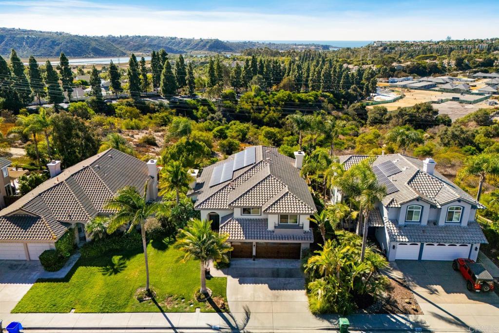 an aerial view of residential houses with outdoor space and street view