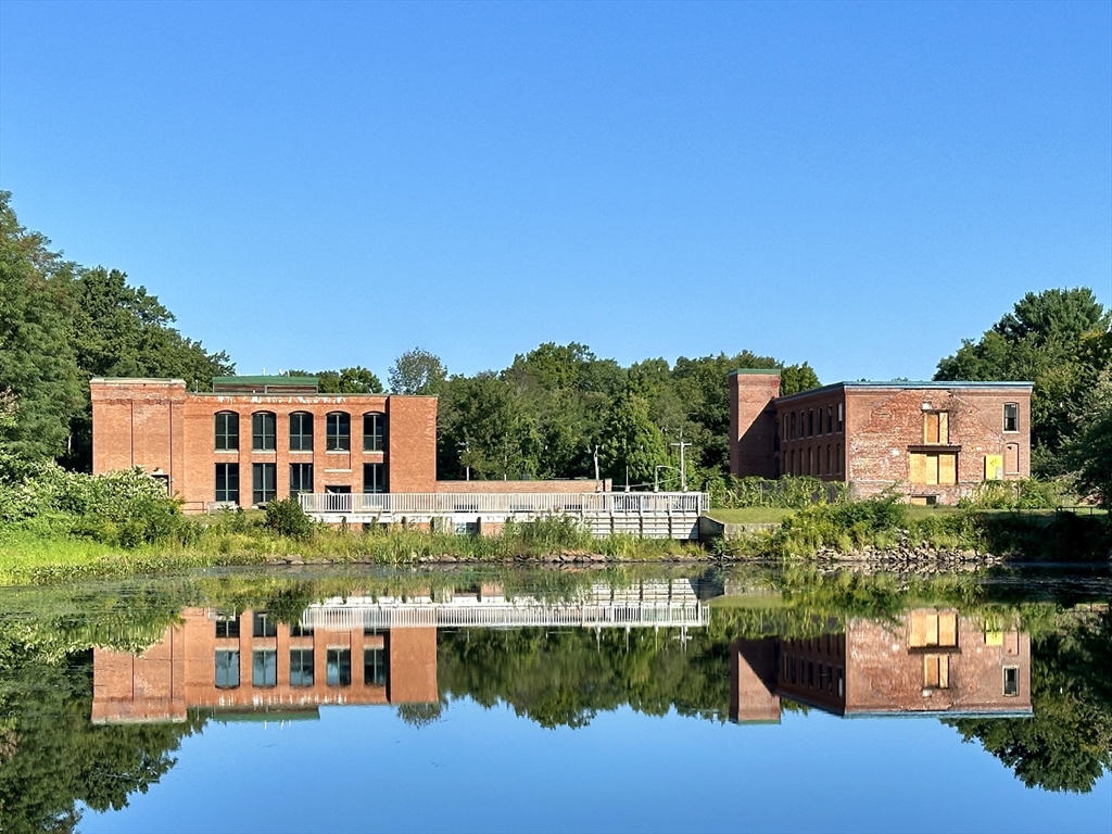 a view of a lake with a house in the background