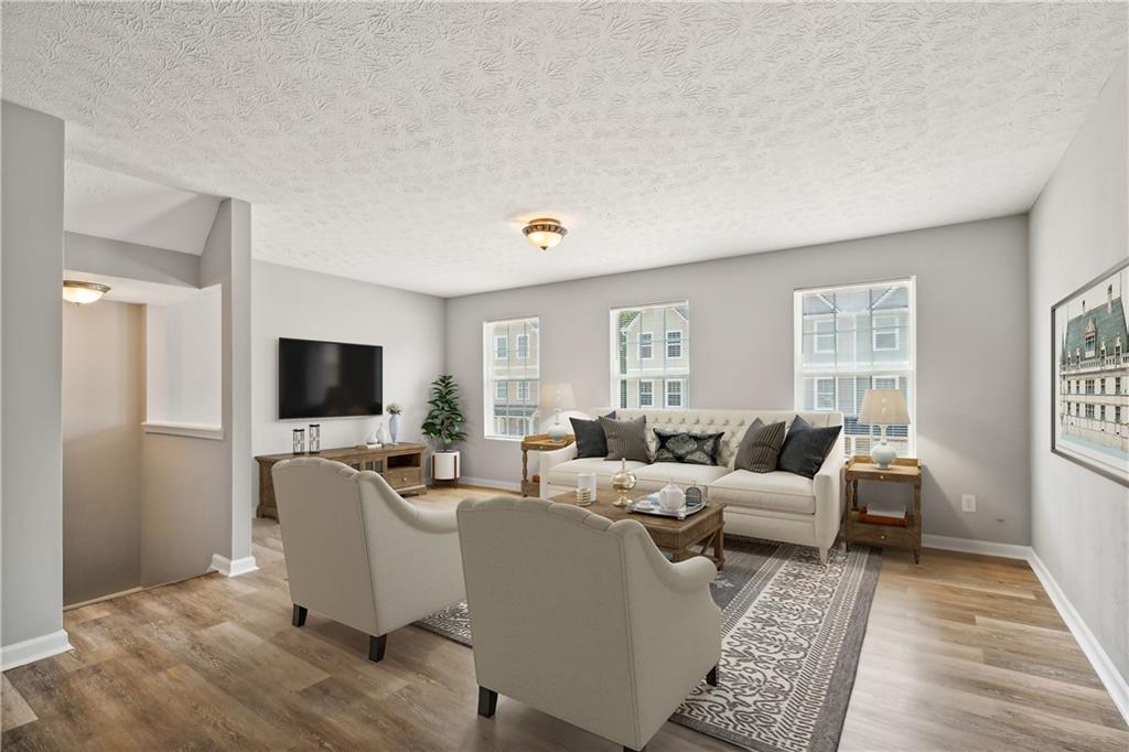 a living room with furniture wooden floor and a flat screen tv