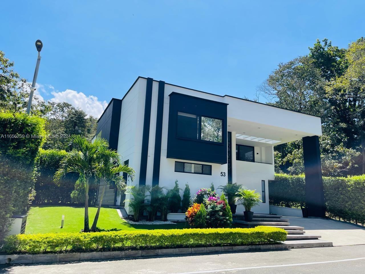 a view of a house with swimming pool and yard