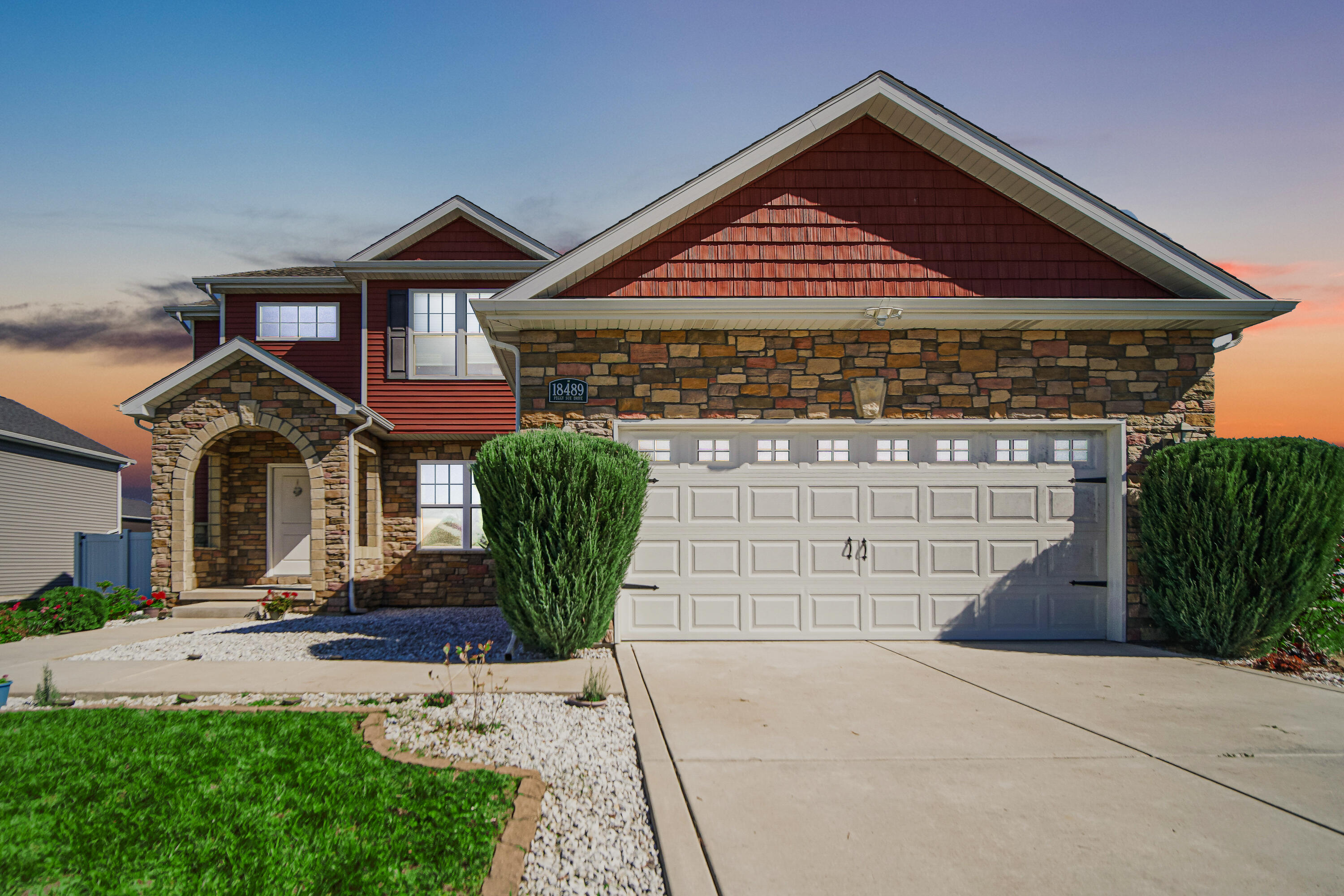 a front view of a house with garden