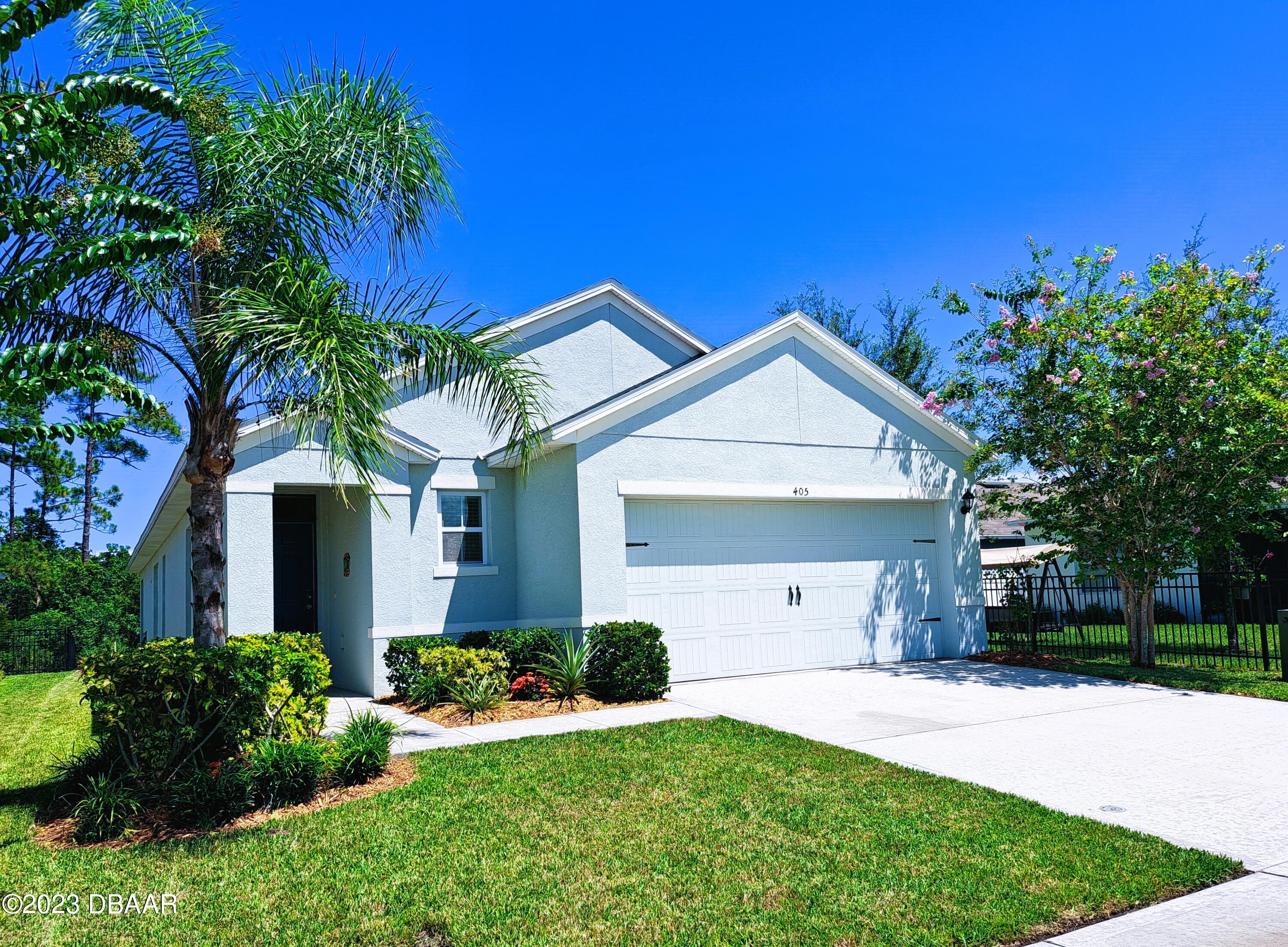 a front view of house with yard and green space