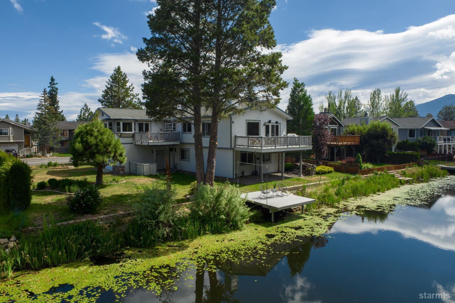 a view of a house with a garden and lake view