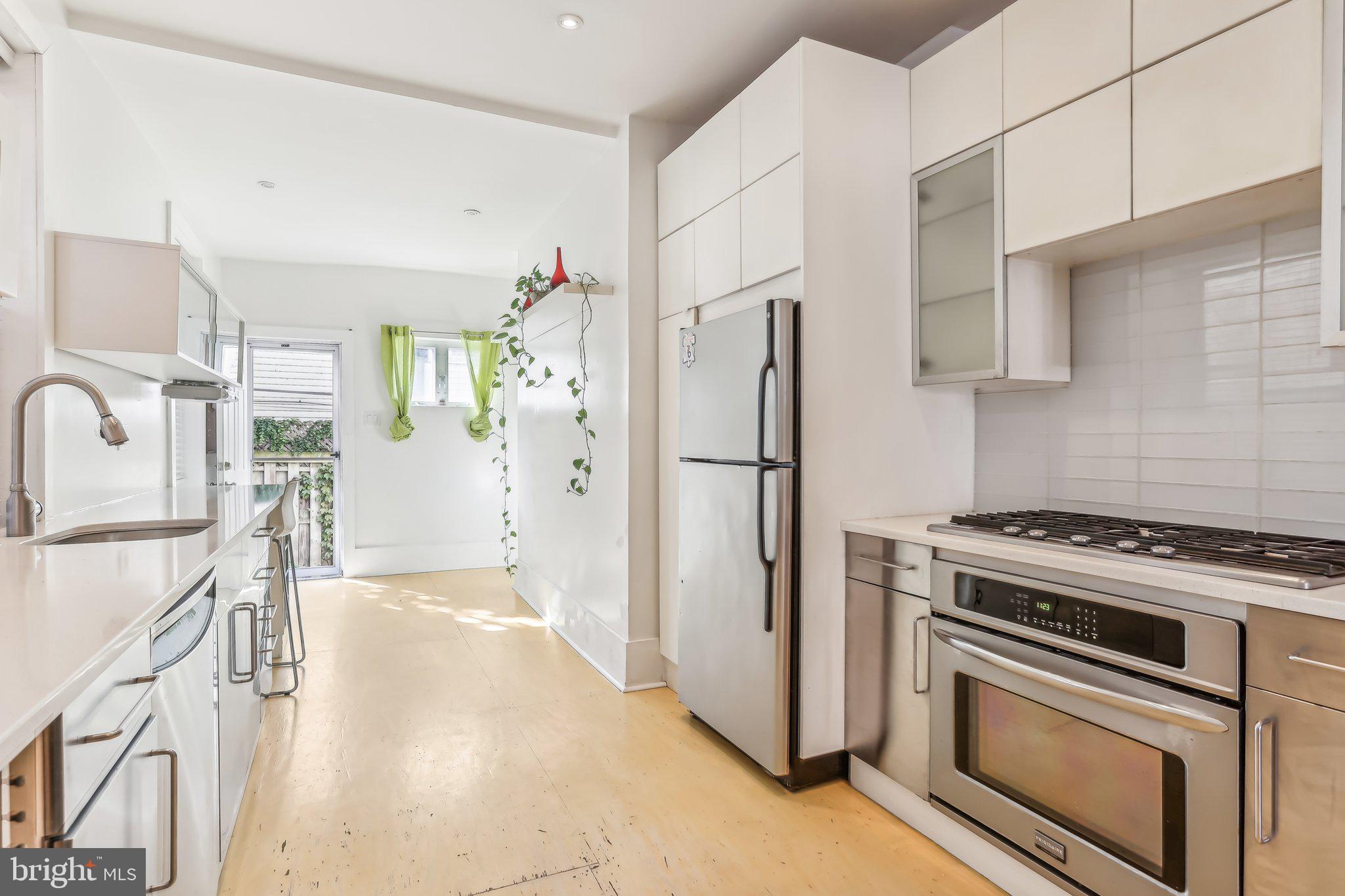 a kitchen with stainless steel appliances a refrigerator stove and sink