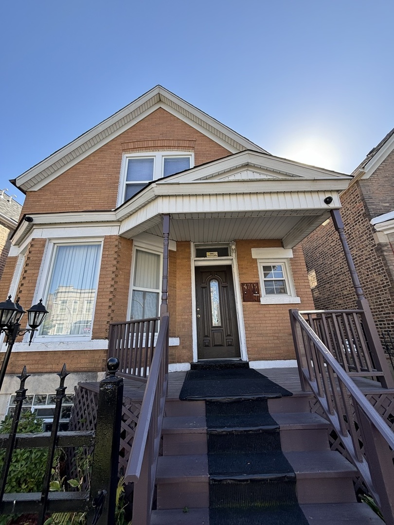 a front view of a house with stairs