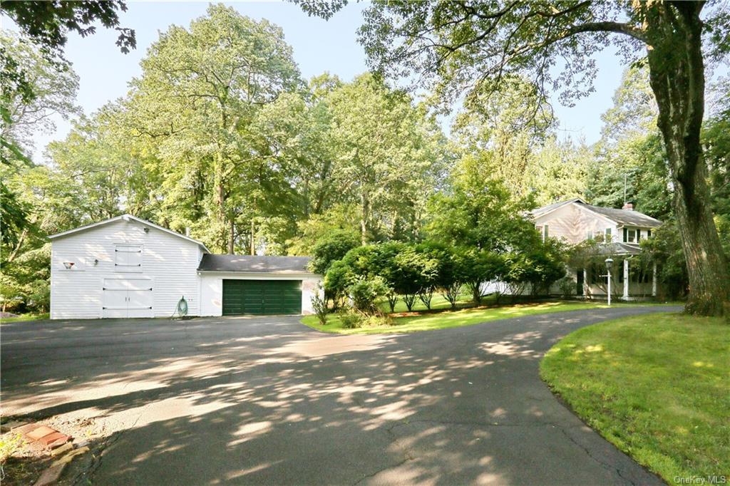 a view of a house with a yard and tree s