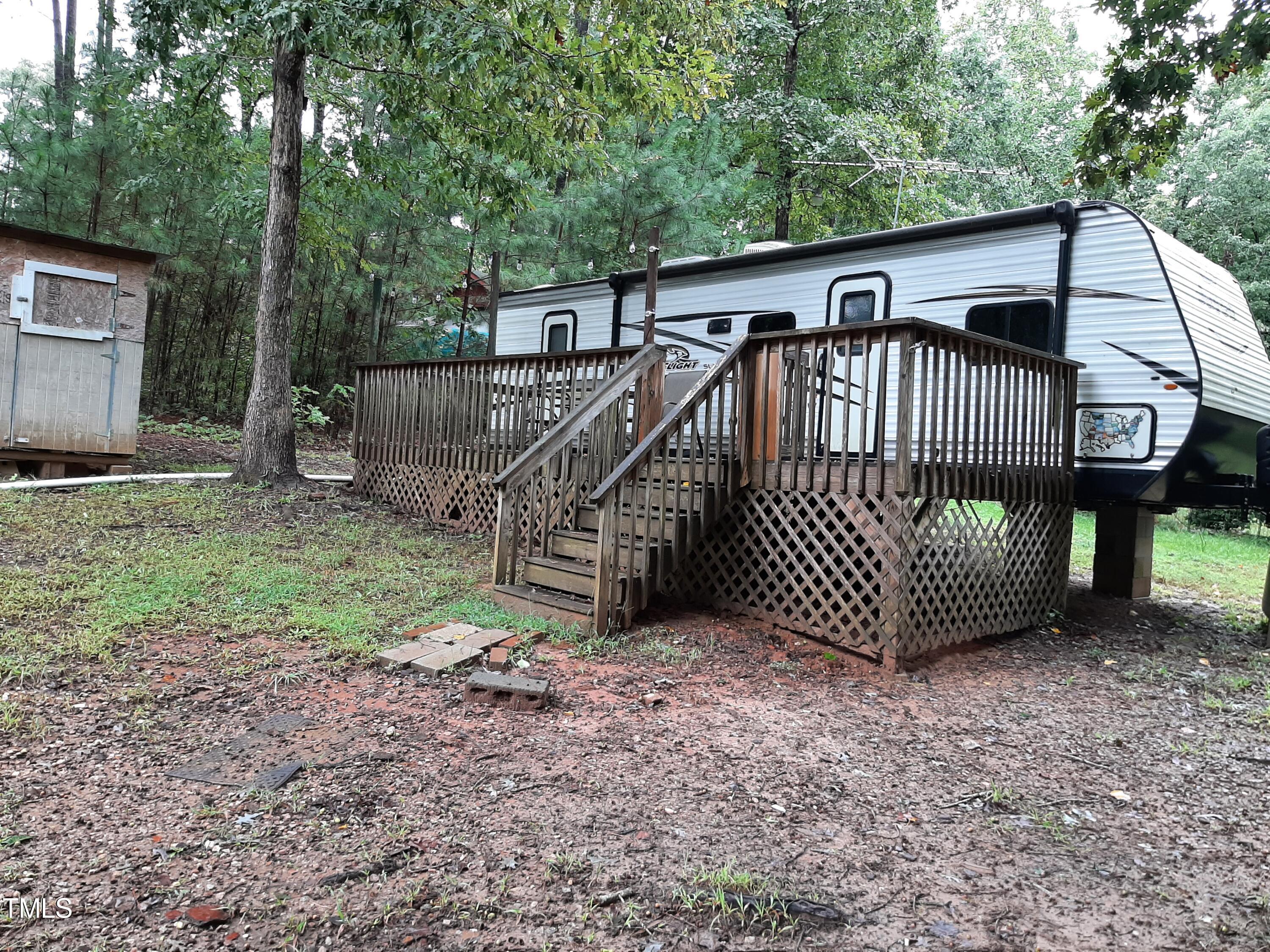 a view of a house with a yard and deck