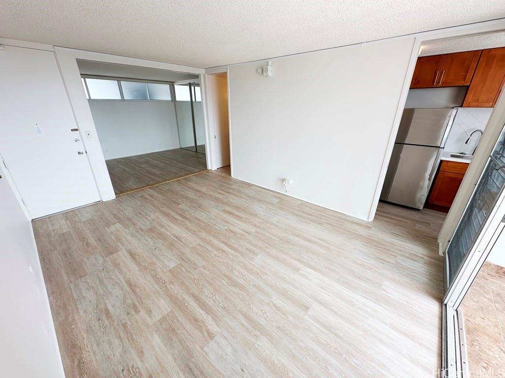 a view of a room with wooden floor and entryway