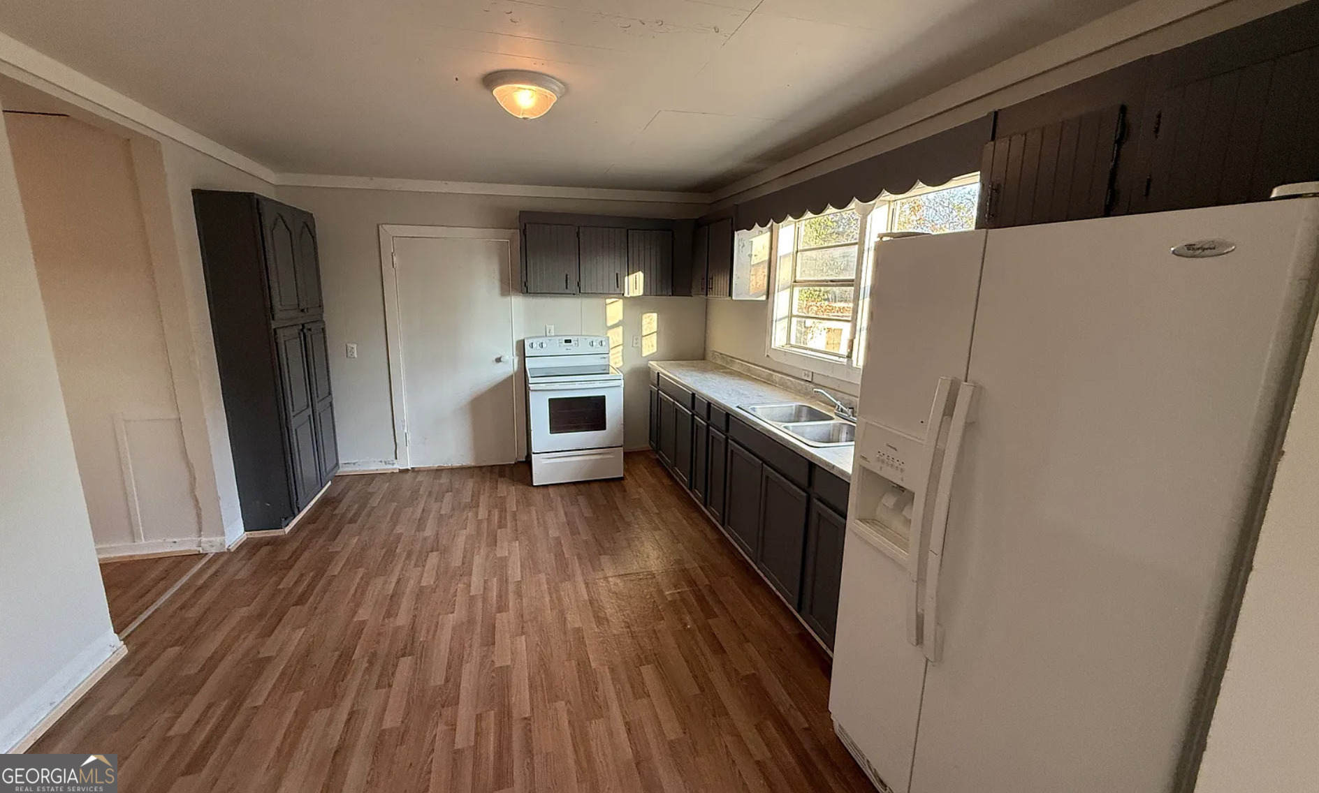 a kitchen with granite countertop a refrigerator and a stove