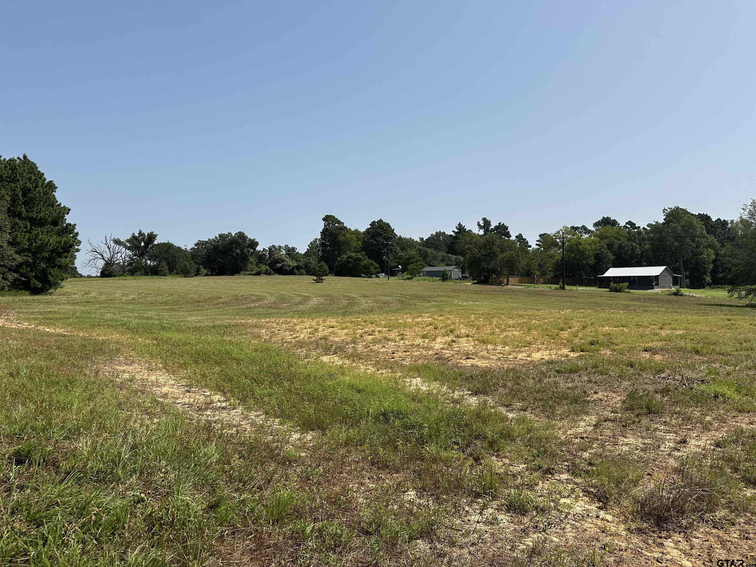 a view of a field with an ocean view