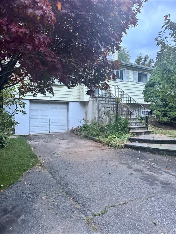 a view of a house with a yard and garage