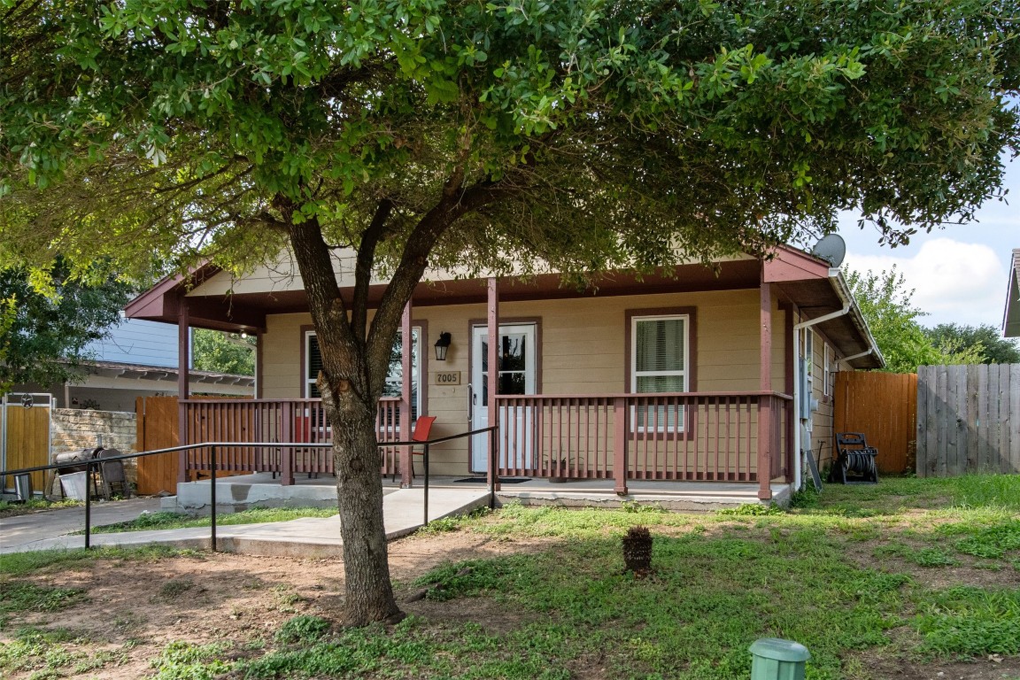 a backyard of a house with barbeque oven