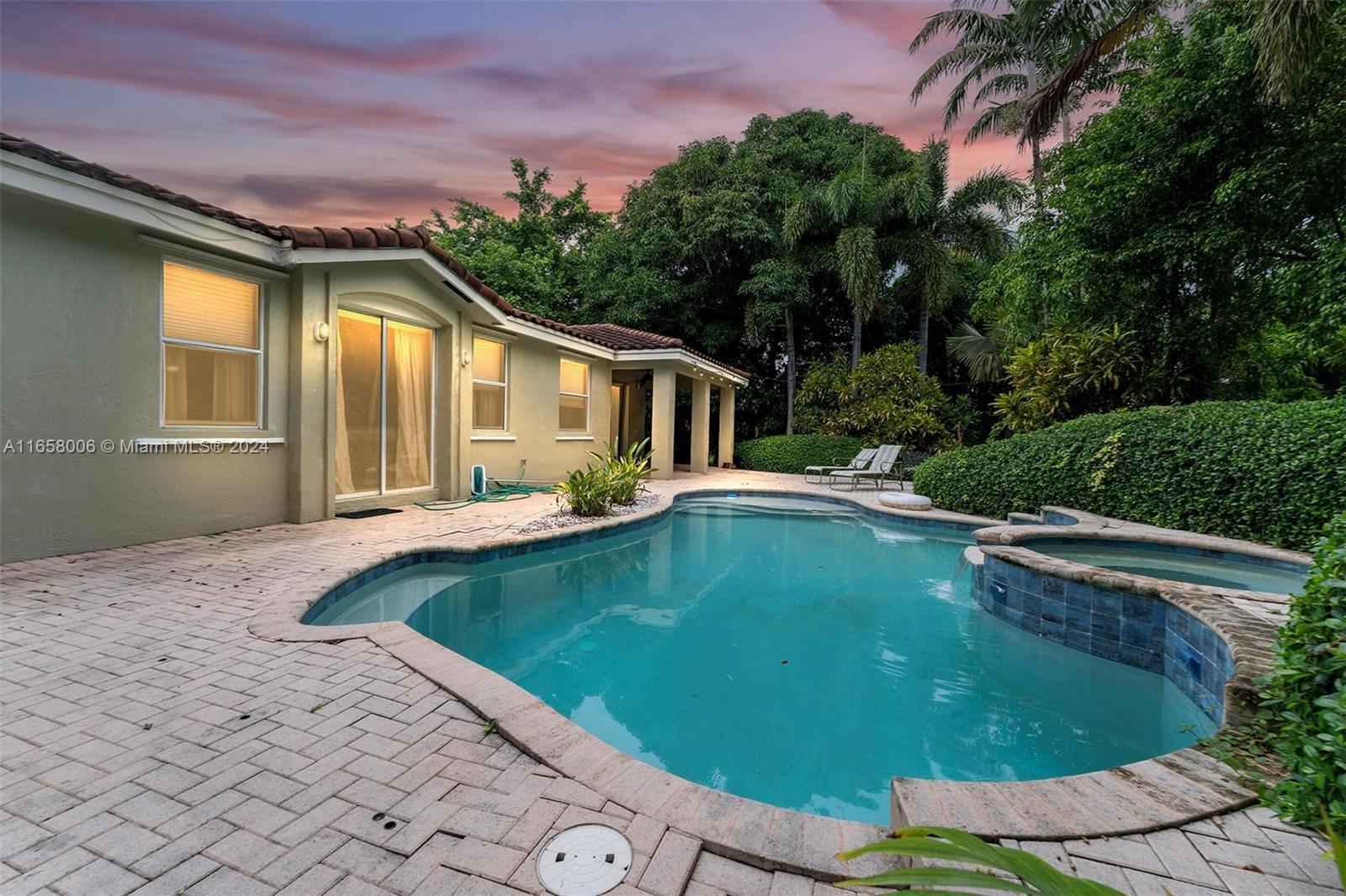 a view of a house with pool and a yard