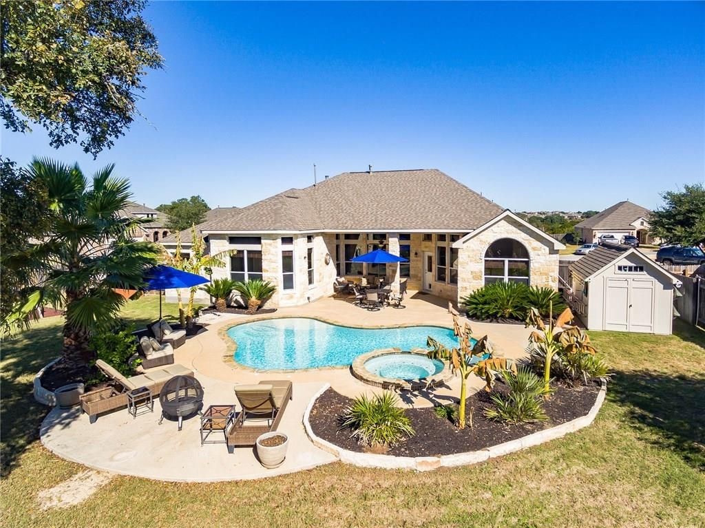 a view of a house with swimming pool and sitting area