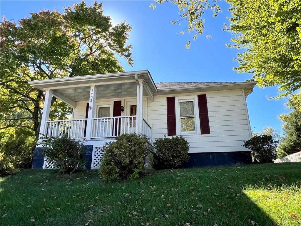 a view of front of house with a yard