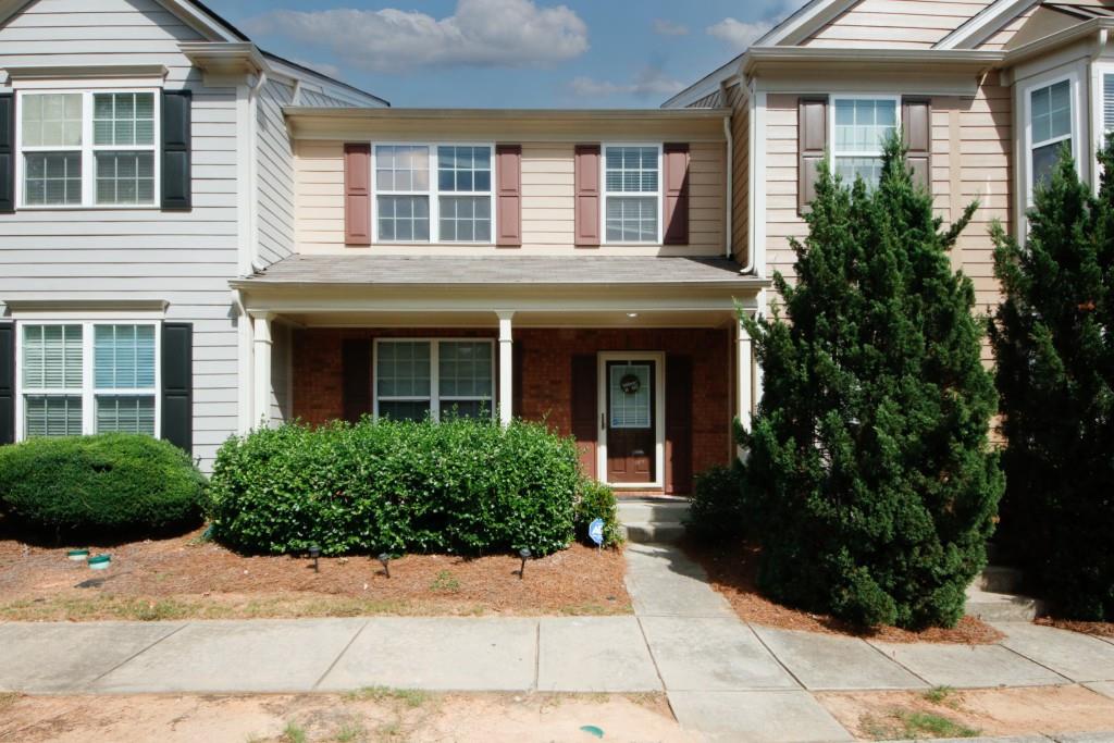 a view of a brick house with a yard