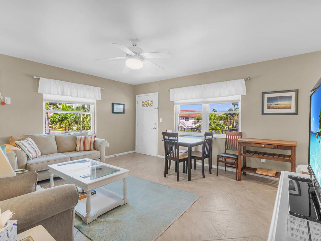 a living room with furniture a table and a large window